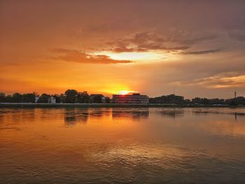 Scenic view of lake against orange sky