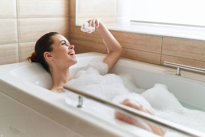 Rear view of woman in bathroom at home