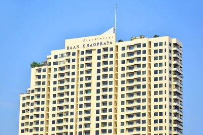 Low angle view of modern building against clear blue sky