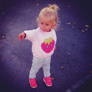 High angle view of cute girl standing on street