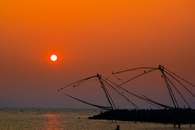 Scenic view of sea against orange sky