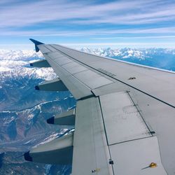 Cropped image of airplane flying over landscape