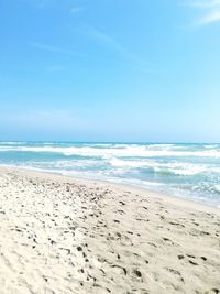 Scenic view of beach against clear blue sky