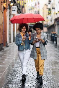 Woman with umbrella walking in rain