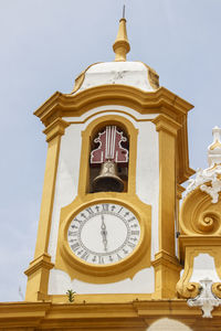 Low angle view of clock tower against sky