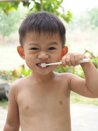 Portrait of boy brushing teeth
