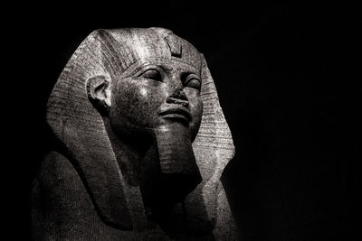 Close-up of statue against black background