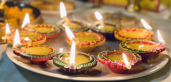 Close-up of illuminated candles on table