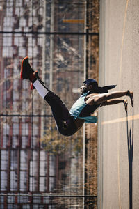 Young man doing handstand on sports court