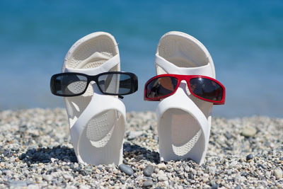 Close-up of sunglasses on pebbles at beach