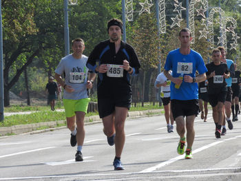 Group of people running on road