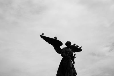 Low angle view of statue against sky