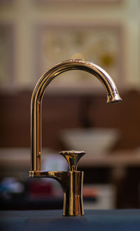 Close-up of faucet in kitchen at home