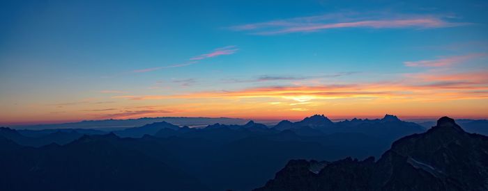 Scenic view of mountains against cloudy sky