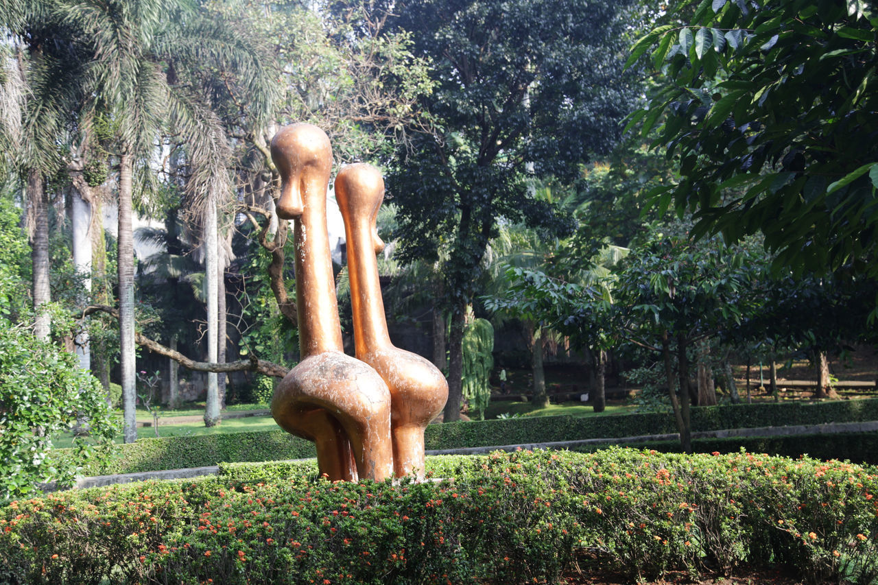 STATUE AGAINST TREES