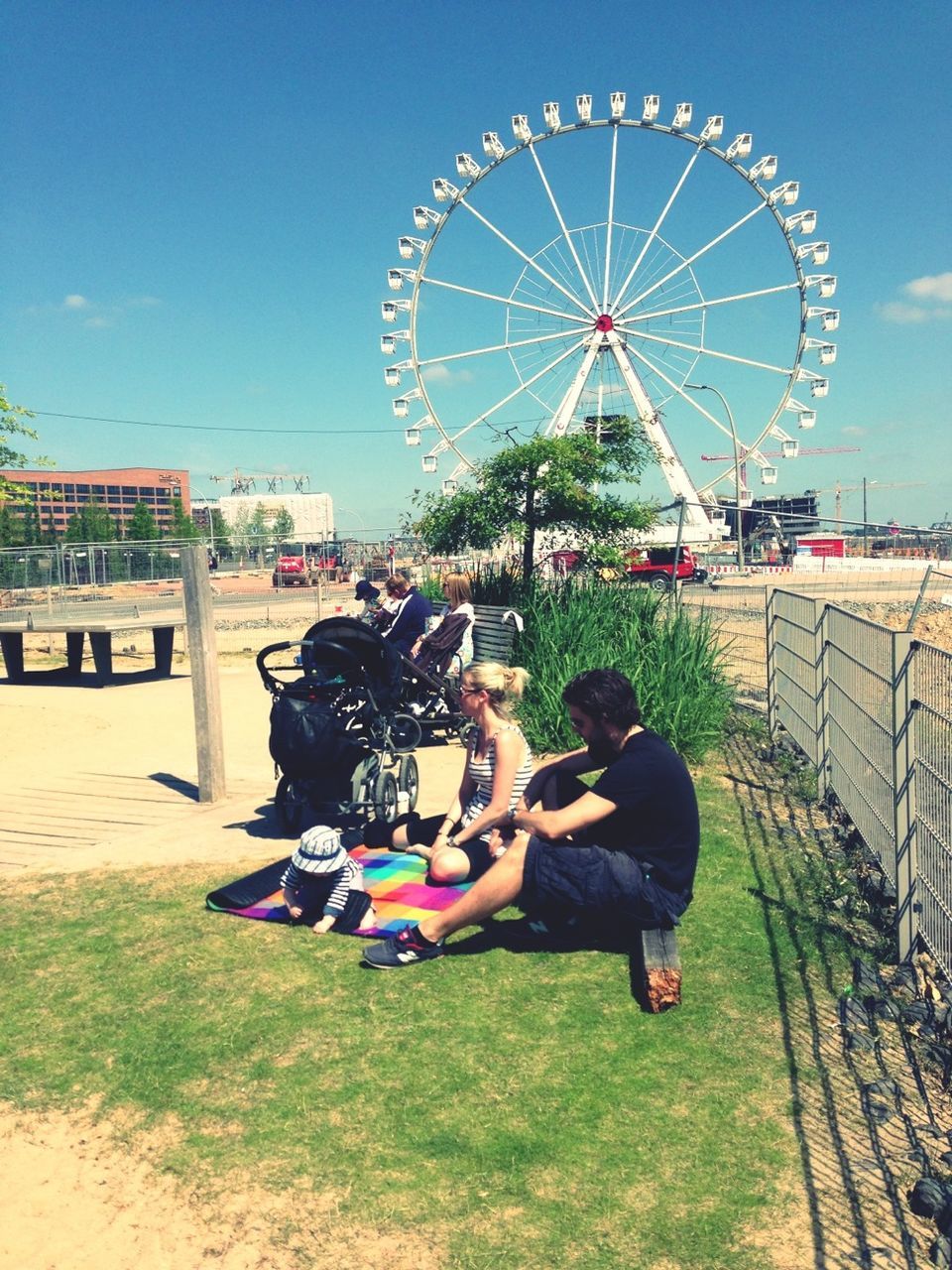 leisure activity, amusement park, arts culture and entertainment, lifestyles, amusement park ride, ferris wheel, enjoyment, men, fun, person, sky, full length, togetherness, boys, rear view, childhood, casual clothing