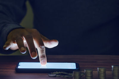 Midsection of man using mobile phone