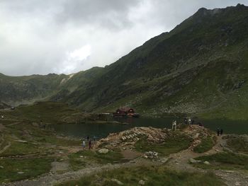 People on mountain against sky