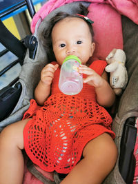 Little girl drinks from her flask