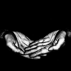 Close-up of man hand against black background