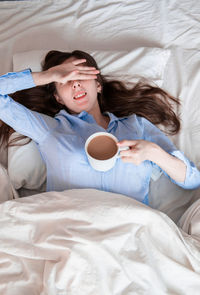 Portrait of young woman sleeping on bed at home