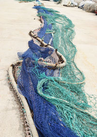 High angle view of fishing net on pavement