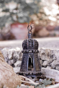 Close-up of old stone cross on rock