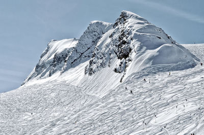 Low angle view of snow covereed mountain against sky