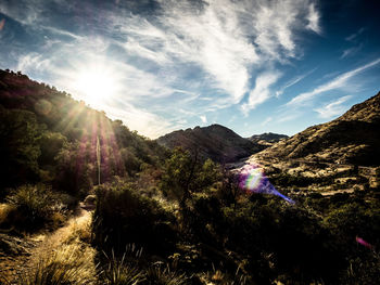 Scenic view of mountains against cloudy sky