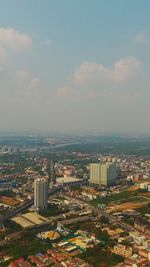 High angle view of illuminated city against cloudy sky