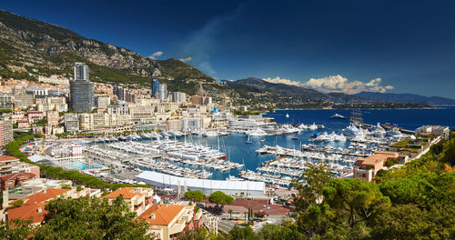 High angle view of townscape by sea against sky