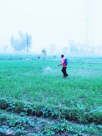 Full length of man standing on field against sky