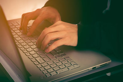 Midsection of man using laptop