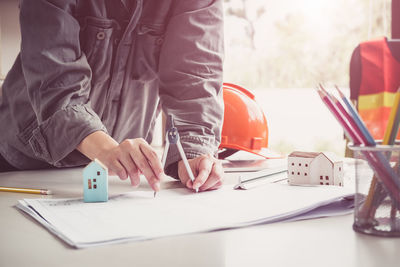 Midsection of man working on table