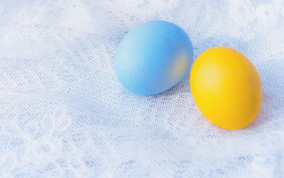 High angle view of multi colored eggs on white surface