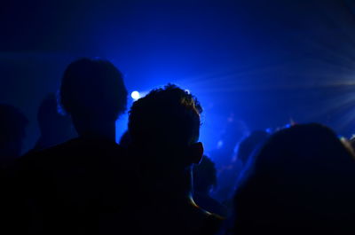 Silhouette people against dramatic sky