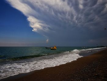 Scenic view of sea against cloudy sky