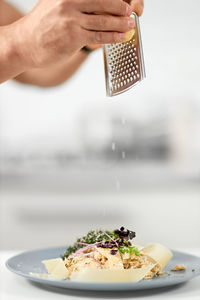 Midsection of person holding ice cream in plate