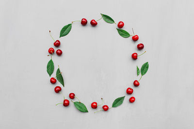 Gray concrete flat lay with big sweet cherries on table background. top view on huge, massive berry