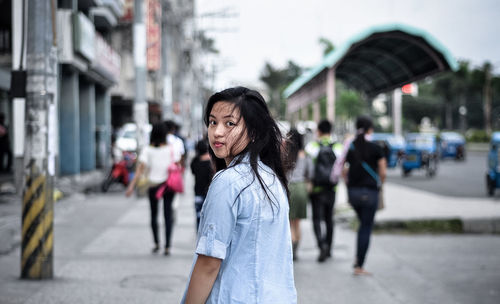 Portrait of woman on street in city