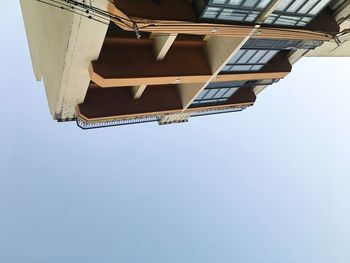 Low angle view of buildings against clear blue sky