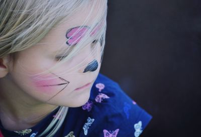 Close-up of cute girl with face paint outdoors