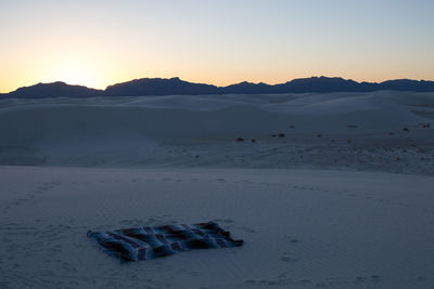 Scenic view of snowcapped mountains against sky during sunset