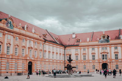 People against historic building