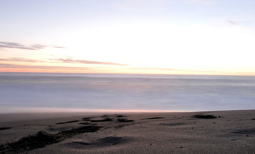 Scenic view of sea against sky at sunset