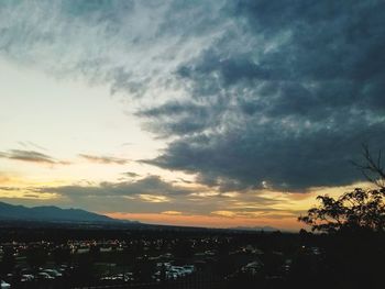 Silhouette cityscape against sky during sunset
