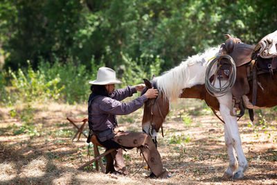 Horse riding horses on field