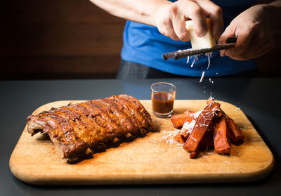 Close-up of hands of a man preparing food