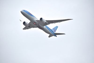 Low angle view of airplane against clear sky