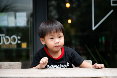 Portrait of cute boy at table